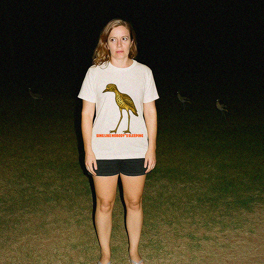 Model wearing Curlew graphic tee with illustrated bush stone-curlew, Darwin NT