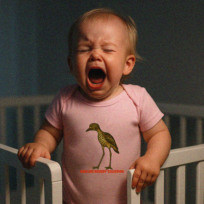 Model wearing Curlew graphic baby jumpsuit with illustrated bush stone-curlew, Darwin NT