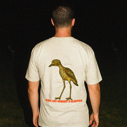 Model wearing Curlew graphic tee with illustrated bush stone-curlew, Darwin NT